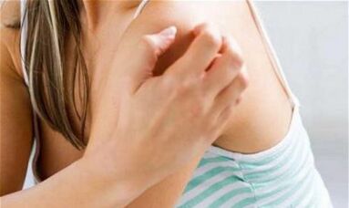 Girl scratches her shoulder